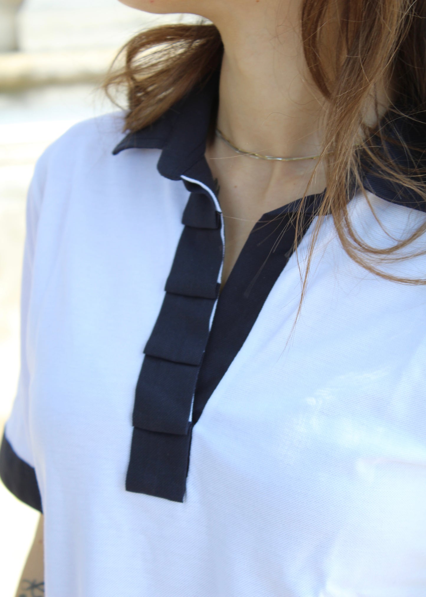 Polo da donna in cotone Strike Inside, manica corta, scollo a V con balze applicate, profili a contrasto su colletto e fondo manica; disponibile nei colori blu, azzurro, bianco e beige. Made in Italy