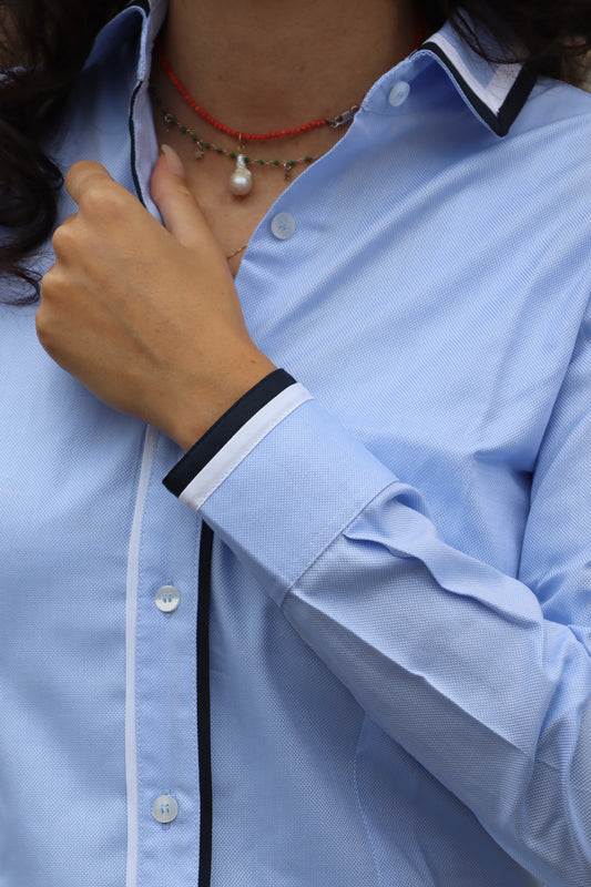 Camicia da donna in cotone con elegante dettaglio bicolore su polsini e colletto. Un capo dal design moderno e ricercato, che valorizza i contrasti cromatici per un look sofisticato e versatile, perfetto per l’ufficio o per occasioni casual chic.