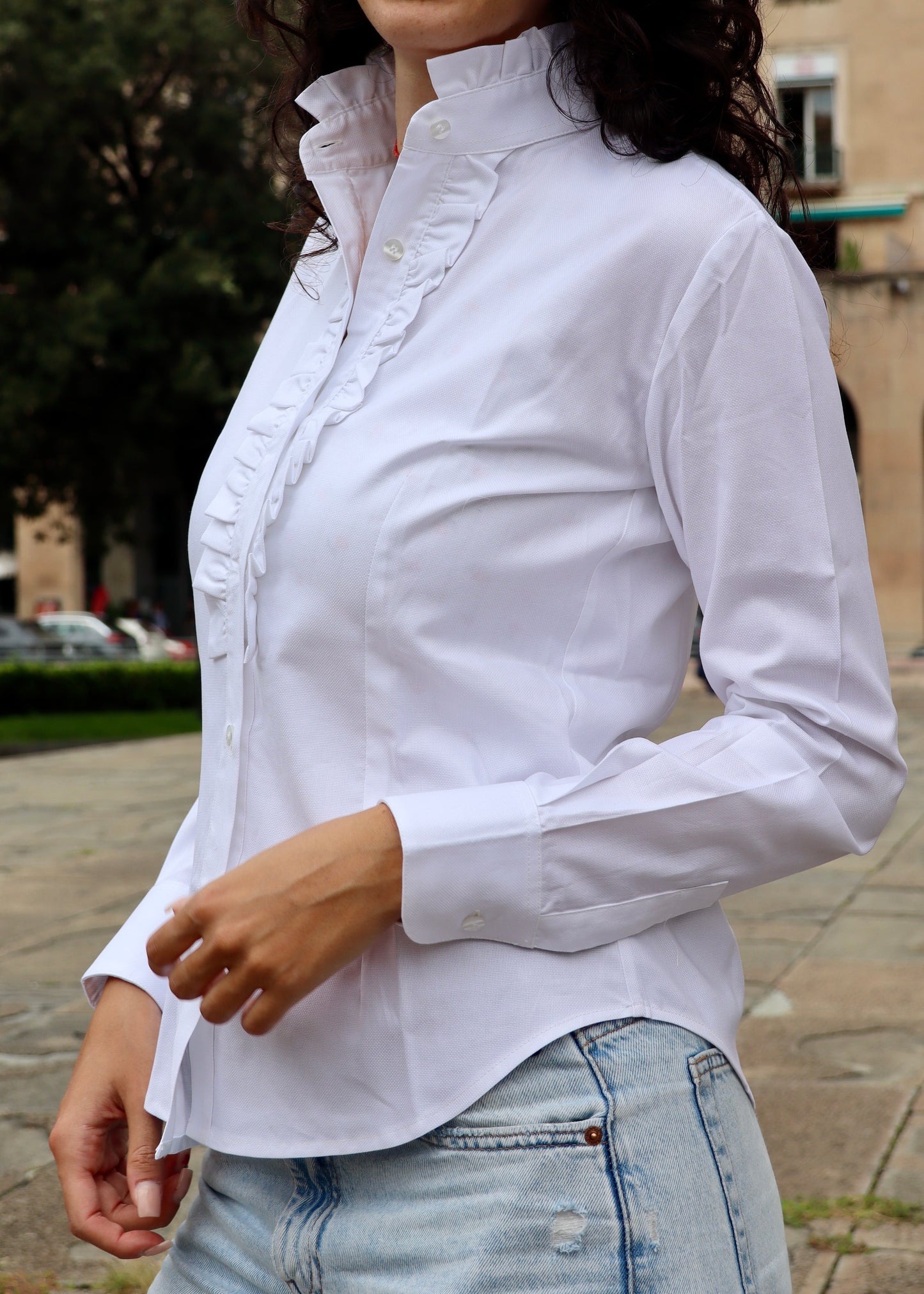Camicia da donna in cotone con rouches decorative sul petto e sul colletto. Un modello femminile e raffinato, caratterizzato da dettagli romantici che donano volume e movimento. Ideale per un look elegante e distintivo, adatto sia a contesti casual chic che a occasioni formali.