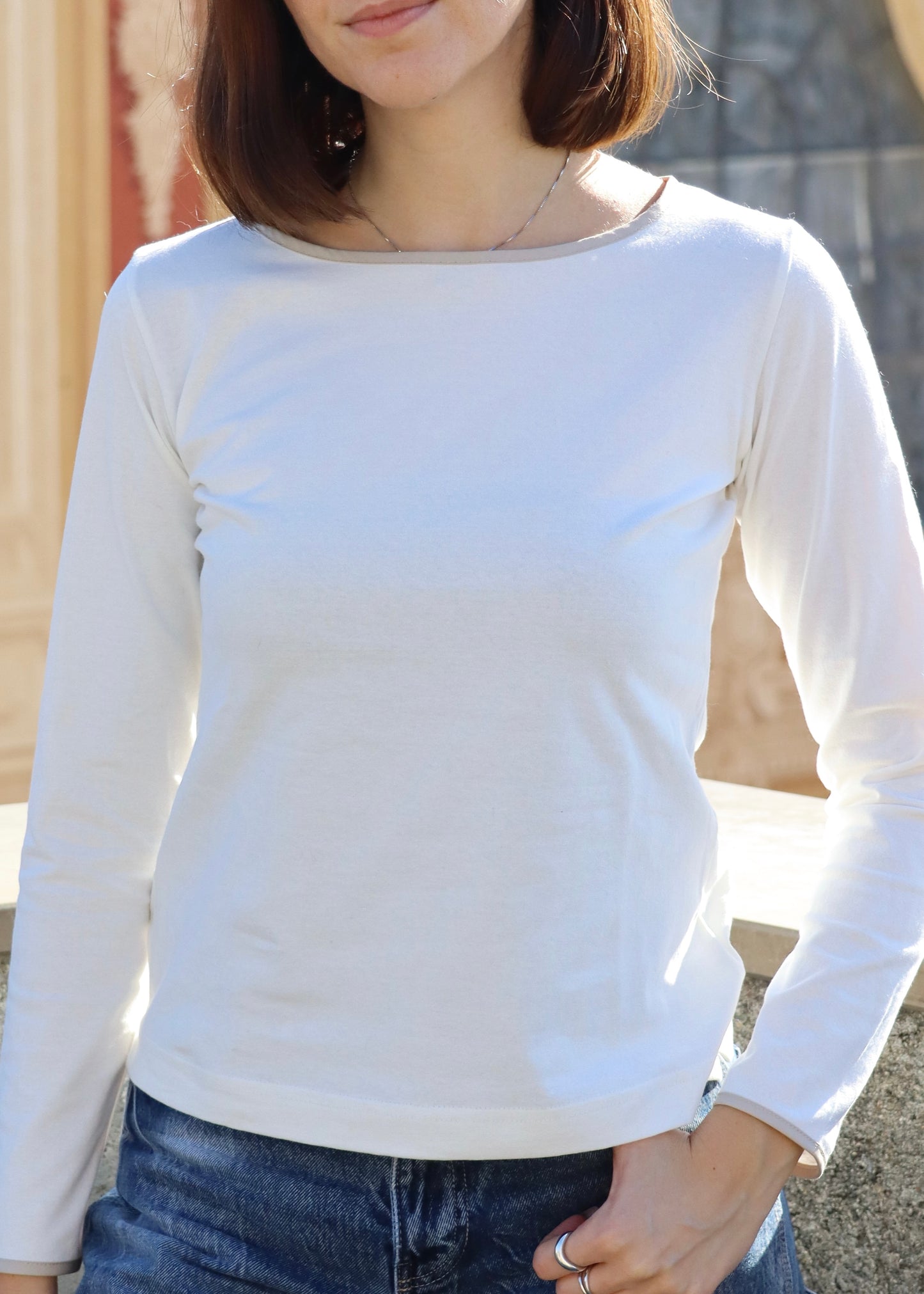 Maglietta da donna con scollo a barchetta in cotone elasticizzato (95% cotone, 5% elastan), realizzata artigianalmente in Italia da Strike Inside Abbigliamento. Il design essenziale è arricchito da bordini colorati su scollo e polsini, che aggiungono un tocco di colore delicato. Morbida, leggera e confortevole, segue le linee del corpo con naturalezza ed è perfetta per un look quotidiano pulito e curato.